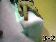 Person Folding Dacron Over Side of Foam