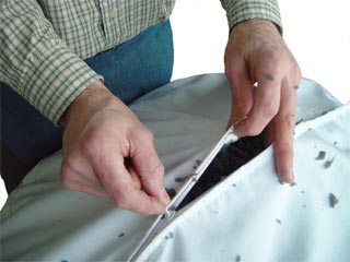 Person Zipping Shredded Foam Into a Foam Liner