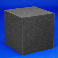 black foam block produced with the CNC Vertical Machine. The block is in front of a blue background.