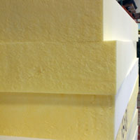 closeup corner photo of three stacked foam sheets produced with the CNC Vertical Machine