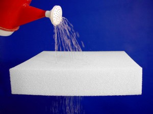 Porous Dryfast Foam A red watering can pouring water on a Porous Dryfast Foam sheet. The water is draining out the bottom of the sheet.