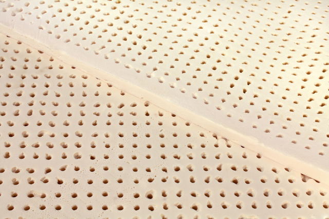 close up of holes in Dunlop Latex Toppers stacked on top of each other