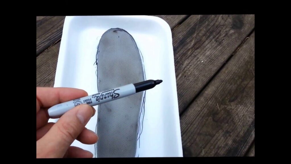 foot shape traced on foam with a Sharpie