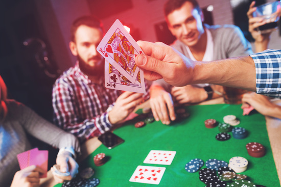 people playing around a poker table