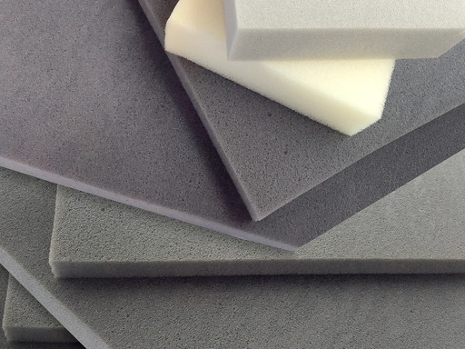 a stack of various sheets and blocks of foam